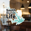 Smith Mountain Life cutout sticker on a glass surface with a teal water outline.