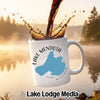 White mug with "Lake Mendota Wisconsin" map and compass design, coffee pouring in.