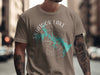 Taupe t-shirt with "Skiatook Lake Oklahoma" text and teal lake outline on compass graphic.