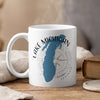 White mug with blue Lake Michigan outline, compass, and "ILLINOIS" text.