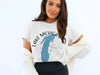 White t-shirt with Lake Michigan silhouette and compass graphic and text.