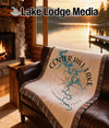 Woven blanket with Center Hill Lake map and compass design on a couch.