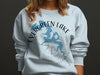 Light blue sweatshirt with Evergreen Lake map and compass design.
