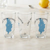 Three clear glasses with blue Lake Derwentwater maps and compass rose graphics.