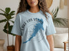 Light blue t-shirt on a woman featuring Lake Las Vegas map with compass design
