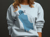 Light blue sweatshirt with Cain Lake, Washington map and compass graphic.