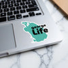 Teal sticker with black text "george Life" on a laptop.