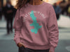 Rose sweatshirt with turquoise West Okoboji Lake graphic and compass design.