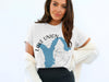 White t-shirt with blue Lake Union map graphic and compass graphic.