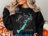 Black sweatshirt with "Tenkiller Ferry Lake Oklahoma" and compass rose graphic.