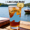 Glass of iced tea with Lake Mendota outline, lemon slice, and "Lake Lodge Media" logo.