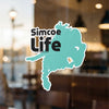 Turquoise sticker with black text "Simcoe Life" and copyright.