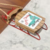 Wooden sled ornament with red runners, featuring a Christmas tag from Lake Gregory.