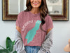 Moraine Lake Alberta t-shirt with teal lake outline graphic on a pink shirt.