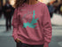 Pink sweatshirt with Hayden Lake Idaho map and compass design.