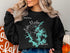 Black sweatshirt with "Beautiful Lake Martin Alabama" map and compass graphic.