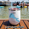 A white insulated wine tumbler featuring a Clear Lake, California map graphic sitting on a wooden boat deck with people swimming in the lake behind it.