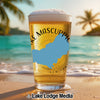 Beer glass with "Lake Mascuppic New Hampshire" text and state outline on a beach.
