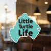 Teal sticker with black text "Little Turtle Life" and copyright.