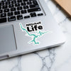 Mitchell Life sticker with teal lake outline on a laptop.