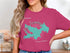 Teal map of Lake Arrowhead, California with compass rose on pink t-shirt.
