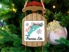 Sled-shaped ornament with "Merry Christmas From American Lake" text and snowflakes.