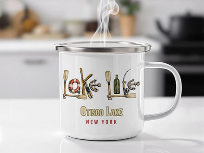 White enamel mug with "Otisco Lake New York" and nautical designs.