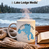 White mug with Yellowstone Lake map and compass, by a window.