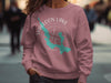 Mauve sweatshirt with Walloon Lake map and compass graphic, 2023.