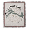 Woven throw with Flagstaff Lake map, compass, and "Maine" text.