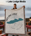 Man holds Dream Lake Colorado blanket with compass rose and mountain silhouette.