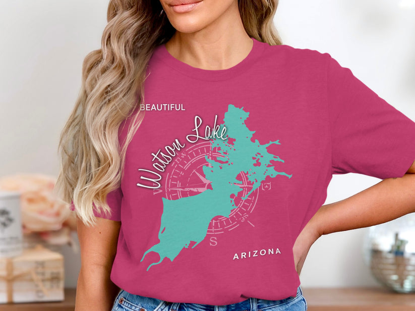 Woman wearing a magenta t-shirt with a turquoise map of Watson Lake.