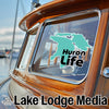 Turquoise map logo with "Huron Life" text on a boat window above "Lake Lodge Media" text.