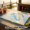 A glass cutting board featuring a blue map of Sam Rayburn Reservoir rests on a wooden dock.