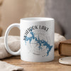 White mug with blue Skiatook Lake map and compass graphic, steaming.