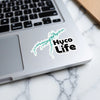 Hyco Life sticker featuring a turquoise lake map shape on a laptop keyboard.