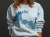 Light blue sweatshirt with Forest Lake, Minnesota map and compass graphic.