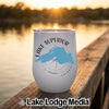 A white stainless steel wine tumbler featuring a blue map of Lake Superior sitting on a wooden dock at sunset.