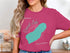 Pink t-shirt with a teal outline map of the Cowichan Lake.