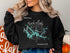 Black sweatshirt with "Beautiful Tim's Ford Lake Tennessee" text and compass rose design.