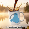 White mug with "Emerald Lake Canada" and map graphic, coffee pouring.