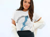 White t-shirt with blue Oologah Lake map design and compass graphic.