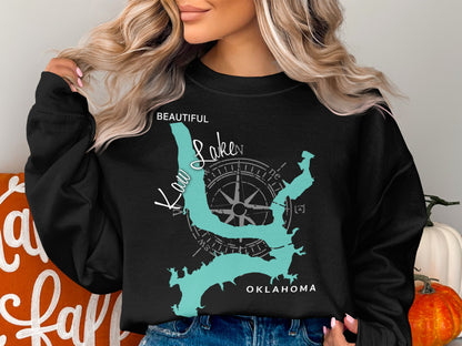 Black sweatshirt with a turquoise map of Kaw Lake, Oklahoma and compass rose.