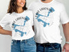 White t-shirts displaying "Lake Lahontan Nevada" with a blue map outline and compass graphic.