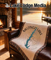 Tapestry throw on leather couch features "Mozingo Lake Missouri" text and compass design.