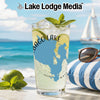 Glass with Maine map and "Bago Lake" on beach with limes and sailboat.