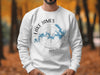 White sweatshirt with blue Lake James map and compass design.
