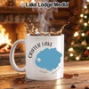 White mug with "Crater Lake Oregon" and compass design, steaming hot coffee.