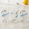 Three clear glasses each featuring a compass and blue map of Lake Icaria, Iowa.