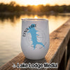 A white insulated wine tumbler featuring a blue outline of Lynx Lake, Arizona sits on a wooden dock.